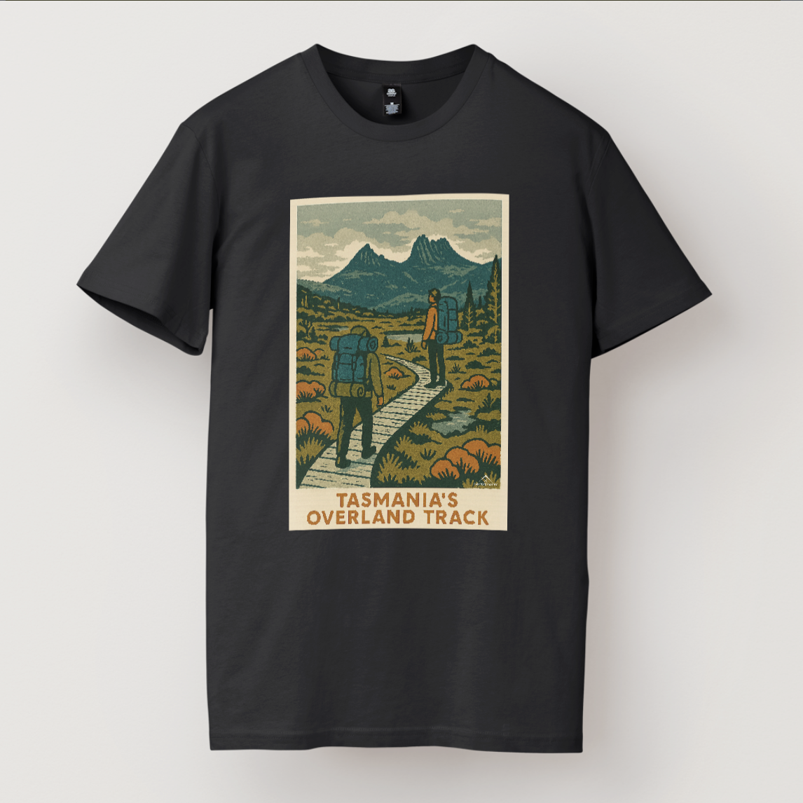 A black Overland Track Trail t-shirt featuring a graphic print of the Overland Track in Tasmania with a mountainous landscape and a hiker on the trail.